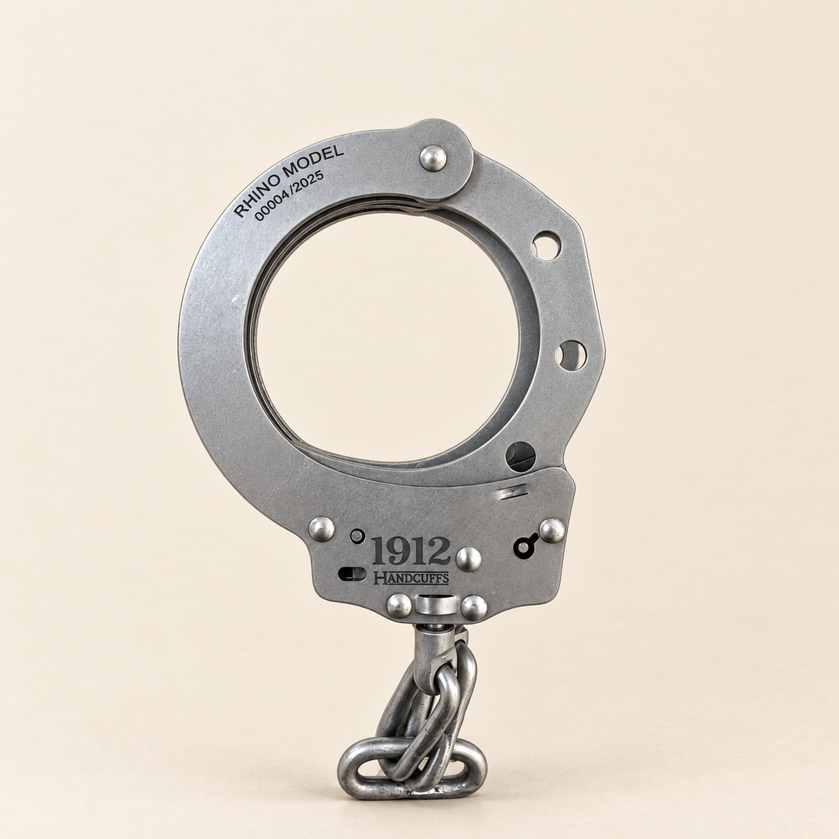 Rhino Chain handcuff on light textured parchment, studio lighting